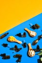 Pills on wooden spoon and dropper pipette on blue and yellow background. Hard light and shadows. Modern isometric creative