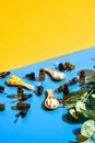 Pills on wooden spoon and dropper pipette on blue and yellow background. Hard light and shadows. Modern isometric creative