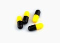 Pills yellow and black capsules isolated on white background Royalty Free Stock Photo