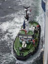 The Pilot along with Two People assisting, on the deck of the Lerwick Pilot Boat approaching the side of a Vessel