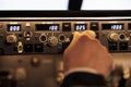 Pilot aviator fixing altitude and longitude level on dashboard