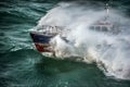 Pilot boat seen from the sky sailing in the middle of a storm Royalty Free Stock Photo