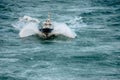 Pilot boat seen from the sky sailing in the middle of a storm Royalty Free Stock Photo