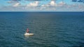 A pilot boat escorts a cruise ship into or out of port from the ocean channel