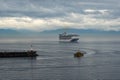 A pilot boat escorts a cruise ship into or out of port from the ocean channel