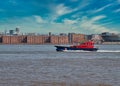 A pilot boat passes the front of the historic Albert Dock buildings on the UNESCO listed Liverpool waterfront on the River Mersey