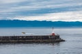 Pilot Boat Past Lighthouse in Blue Dawn Royalty Free Stock Photo