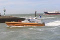 A pilot boat sails into the harbour of terneuzen in summer