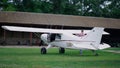Pilot checking private plane standing green airfield. Making preflight procedure Royalty Free Stock Photo