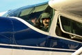 Pilot and co-pilot in cockpit of Cessna 180