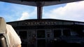 Pilot in the cockpit of a small commercial aircraft above a rural landscape, cloudy sky background. Pilots in the Royalty Free Stock Photo