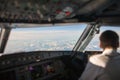 Pilot in a commercial airliner airplane flight cockpit Royalty Free Stock Photo