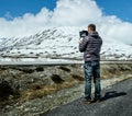 Pilot controls the drone performing flight over the mountains