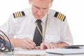 Pilot filling in logbook and checking papers