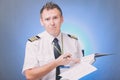 Pilot filling in logbook and checking papers Royalty Free Stock Photo