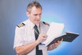 Pilot filling in logbook and checking papers Royalty Free Stock Photo