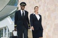 Pilot And Flight Attendant Walking Outside Building Royalty Free Stock Photo