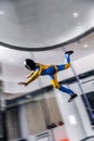 Pilot. Fly men is a pilot of his body in air. Extreme people prefer skydiving. Parachutist in blue and yellow suit. Free