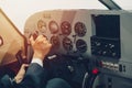 Pilot hand or private flight captain control airplane with many aircraft gauge in cockpit dashboard