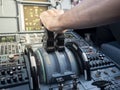 Pilot hand on thrust lever in A320 aircraft. warm sunlight in cockpit. Concept of power.