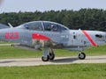 The pilot of a historic fighter waving from the cockpit before takeoff