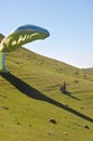 Pilot landing parachute on the mountain with traveler