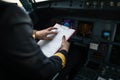 Pilot`s hand in a commercial airliner airplane flight cockpit during takeoff