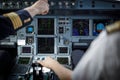 Pilot`s hand in a commercial airliner airplane flight cockpit during takeoff