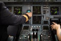 Pilot`s hand in a commercial airliner airplane flight cockpit during takeoff