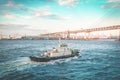 pilot ship or Tug ship in is guiding a large Cruise ship boat out to the ocean in Yokohama Japan Royalty Free Stock Photo