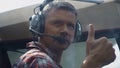 Pilot showing thumbs up sitting airplane cockpit ready to flight close up.