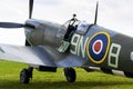 Pilot sits in cockpit of Supermarine Spitfire british fighter aircraft