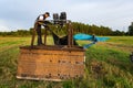 Pilot standing on the basket of landed hot air balloon and preparing all elements for transportation Royalty Free Stock Photo