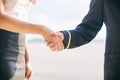 Pilot and stewardess shaking hands.