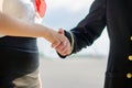 Pilot and stewardess shaking hands.