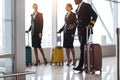 pilot and stewardesses with luggage walking Royalty Free Stock Photo