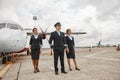 Pilot and stewardesses on runway near airplane jet Royalty Free Stock Photo