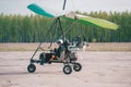 Pilot is using a smart phone and smiling while doing selfie in moto hang-glider