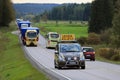 Pilot Vehicle Leads Convoy of Wide Load Transports