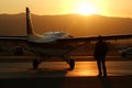 Pilot walking away after a mission at sunset. Neural network AI generated Royalty Free Stock Photo