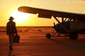 Pilot walking away after a mission at sunset. Neural network AI generated Royalty Free Stock Photo