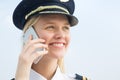 A pilot woman making a phone call at the airport. International global telecommunications