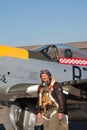 Pilot in the WWII uniform stands near Mustang