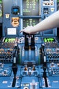 Piloting in an Airplane Cockpit with thrust levers with hand on top for takeoff Royalty Free Stock Photo