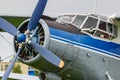 Pilots cabin and engine with four blade propeller of blue and silver soviet biplane aircraft Antonov AN-2