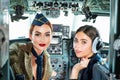 Pilots Sitting in Cabin. Young Woman With Headset. Portrait of two attractive young women pilots with headset preparing Royalty Free Stock Photo