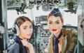 Pilots Sitting in Cabin. Young Woman With Headset. Portrait of two attractive young women pilots with headset preparing Royalty Free Stock Photo