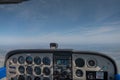 Pilots  view - cockpit and sky in a old used single engine piston airplane with flight instruments, radios & navigation equipment Royalty Free Stock Photo