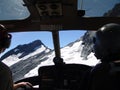 Pilots' view during the flight over mountains from the helicopter cabin Royalty Free Stock Photo