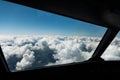 Pilots view out of the cockpit window toward clouds and blue sky above Royalty Free Stock Photo